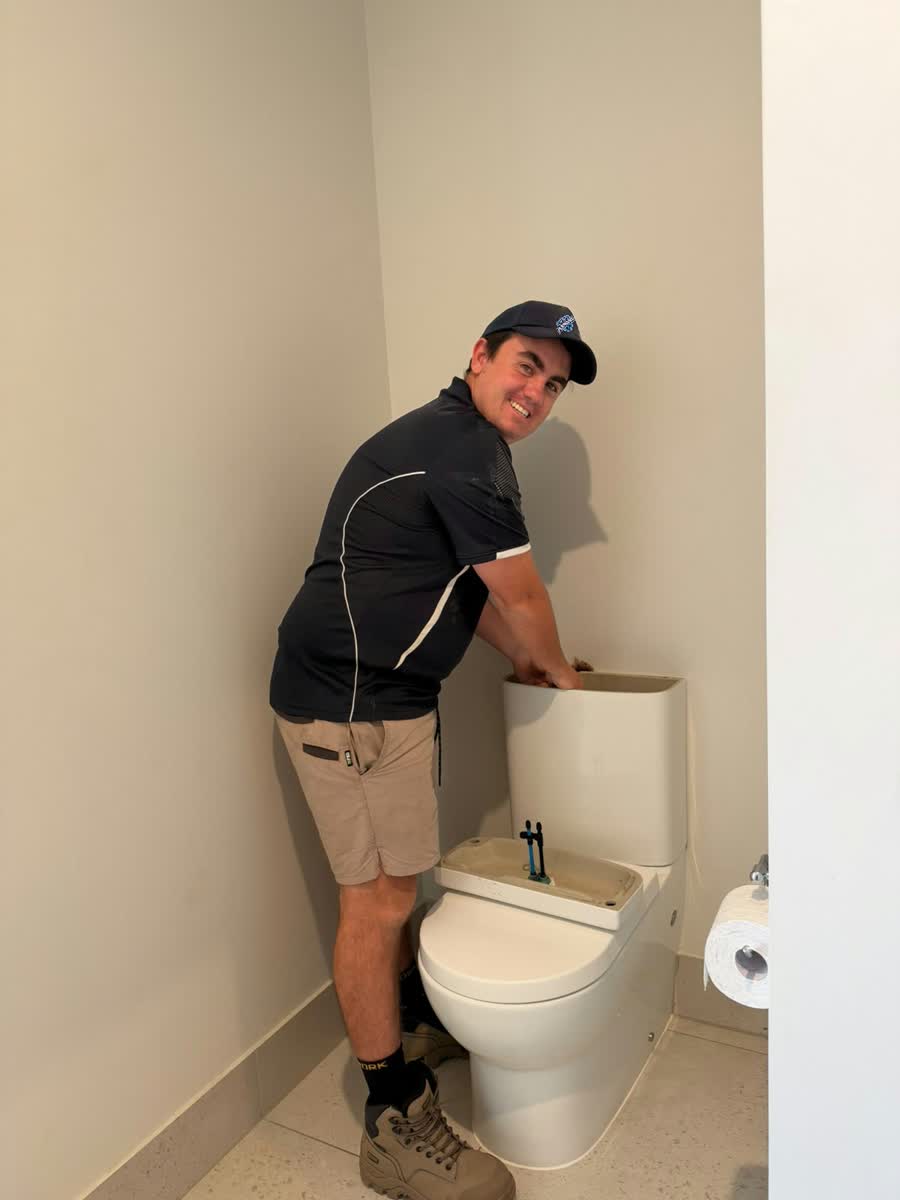 Two Tip Top Plumbing plumbers repairing a pipe in a trench