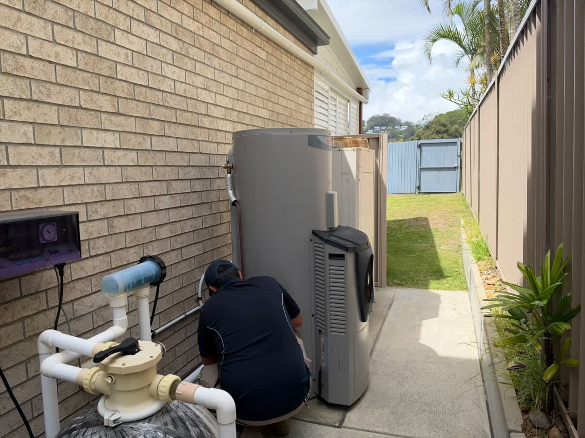 Tip Top Plumbing plumber working on a heat pump hot water system