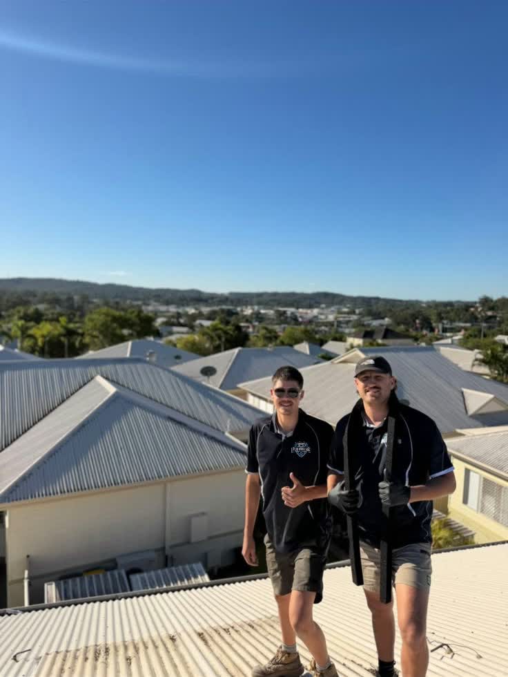 Two Tip Top Plumbing plumbers on a roof